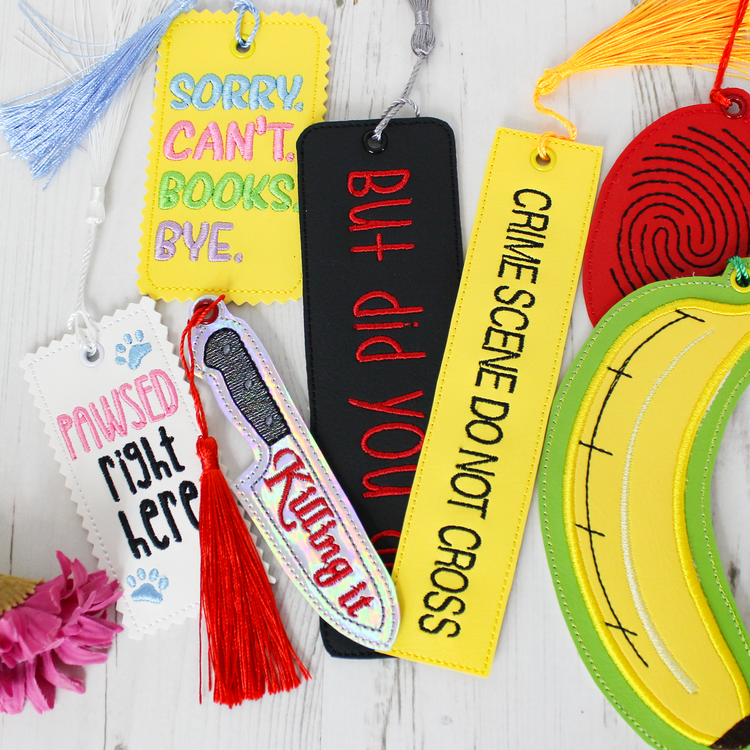 a range of handmade embroidered quirky, novelty crime themed bookmarks with tassels on a white background