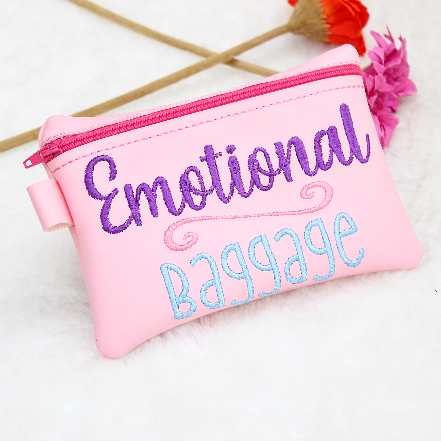 Pink pouch with 'Emotional Baggage' text on a white background