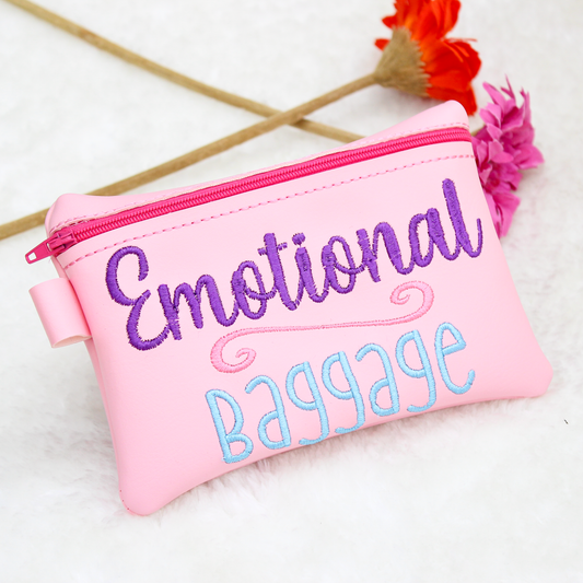 Pink pouch with 'Emotional Baggage' text on a white background with flowers.